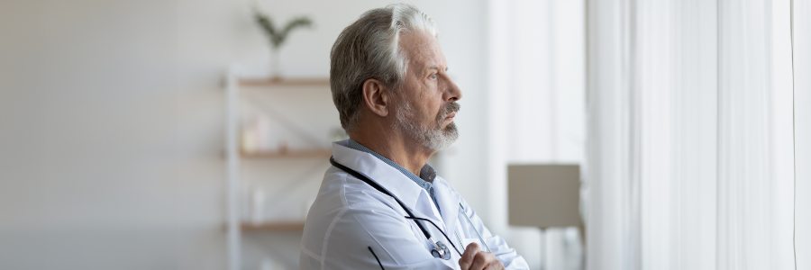 A physician standing and looking into the distance