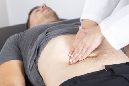 Doctor giving a gastrointestinal examination to a patient